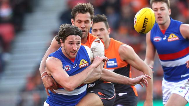 Western Bulldogs Marcus Bontempelli releases the ball under pressure from Matt De Boer. Picture: Phil Hillyard.