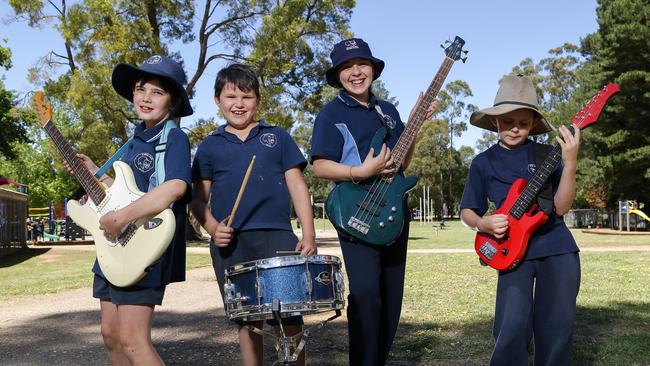 Kinglake West Primary students Sonny, Robert, Camryn and Cohen enjoy the donated instruments. Picture: George Salpigtidis