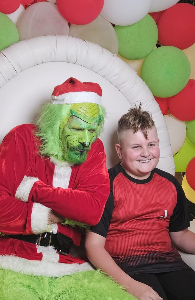 Parker Vickery with the Grinch: Carols in the Gardens - Mackay. Sent in by Simone Parker.