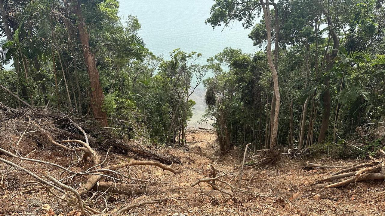 Landslides run for hundreds of metres down cliff faces and into the ocean on the Bloomfield Track between Wujal Wujal and Cape Tribulation.