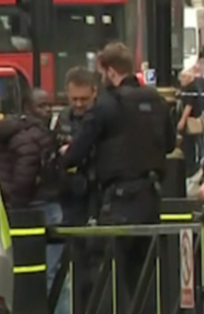 Armed police have surrounded a car and arrested a man after a number of pedestrians were hit before ploughing into security barriers outside Parliament in London. Picture: Supplied