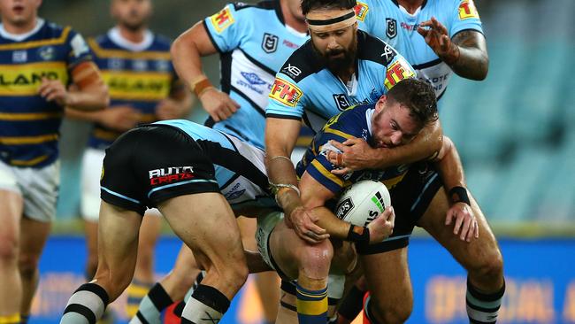 Clint Gutherson is wrapped up by the Sharks defence. Picture: Getty Images