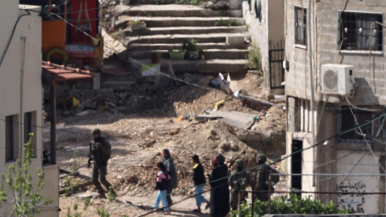 Israeli soldiers lead a Palestinian family out of their home during a raid in the Nur Shams refugee camp in the occupied West Bank on April 20. Picture: AFP