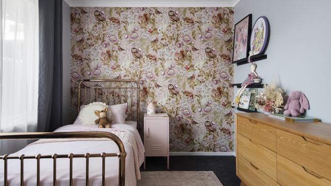 Owl and floral-patterned wallpaper in one of the bedrooms.