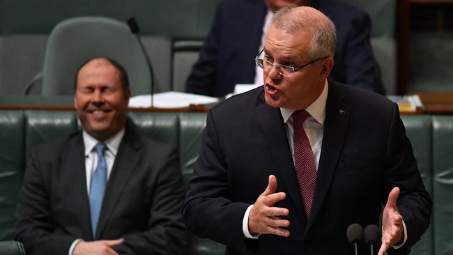 Scott Morrison reacts to Anthony Albanese during Question Time on Thursday while Treasurer Josh Frydenberg laughs in background. Picture: Getty Images