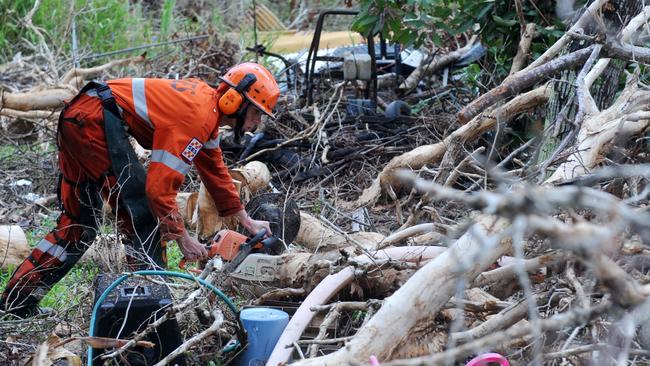 Ten anniversary of Cyclone Yasi. Recovery from Cyclone Yasi 2011. SES volunteer Stefan Buick from Canberra clears tree litter from a house at Tully Heads. Picture: Evan Morgan