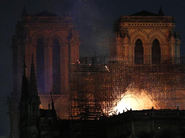 Notre Dame cathedral is burning in Paris, Monday, April 15, 2019. A catastrophic fire engulfed the upper reaches of Paris' soaring Notre Dame Cathedral as it was undergoing renovations Monday, threatening one of the greatest architectural treasures of the Western world as tourists and Parisians looked on aghast from the streets below. (AP Photo/Francois Mori)