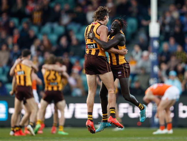 MELBOURNE, AUSTRALIA - JUNE 08: Changkuoth Jiath and Jack Scrimshaw of the Hawks react after the final siren during the 2024 AFL Round 13 match between the Hawthorn Hawks and the GWS GIANTS at UTAS Stadium on June 08, 2024 in Launceston, Australia. (Photo by Dylan Burns/AFL Photos via Getty Images)