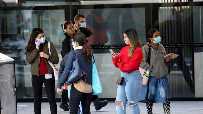 Mask-wearing commuters at Chatswood station. Picture: Damian Shaw