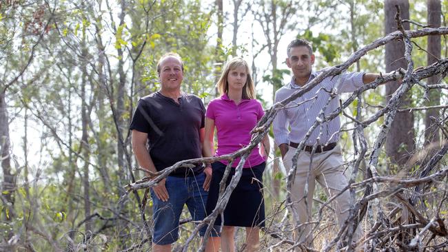 Greg Thomson, Simone Karandrews and Kanchan Bandyopadhyay show the heavy fuel load in the Pullenvale area, which they say is a problem across the inner west. Picture: AAP/Sarah Marshall