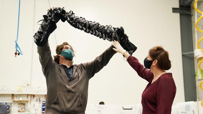 Workers James Farren and Jane Kerrigan inspect masks at a Carrum Downs factory based in Melbourne.