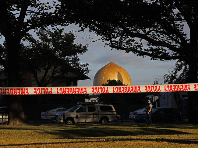 Aa police officer stands guard in front of the Masjid Al Noor mosque in Christchurch, New Zealand, where one of two mass shootings occurred. Picture: AP