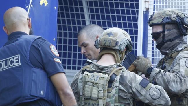 Shem Reece Rotumah is arrested following a six-hour siege in the heart of the Darwin CBD on Thursday. Picture Glenn Campbell