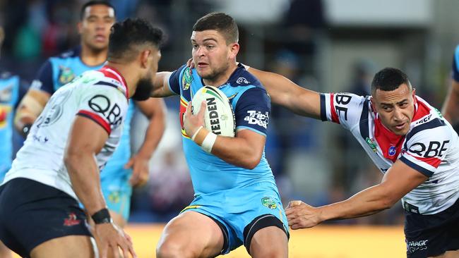 GOLD COAST, AUSTRALIA - JULY 15: Ash Taylor of the Titans is tackled during the round 18 NRL match between the Gold Coast Titans and the Sydney Roosters at Cbus Super Stadium on July 15, 2018 in Gold Coast, Australia. (Photo by Chris Hyde/Getty Images)