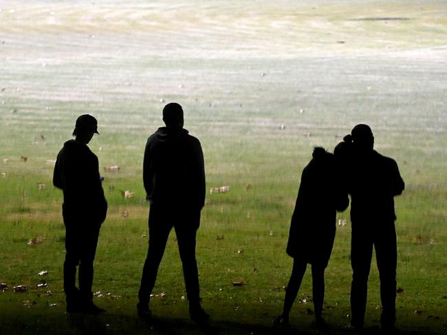 Team mates and friends of the Singleton Roosters Aussie Rules Club gathered for a vigil at their home ground on Tuesday night. Picture: Jeremy Piper