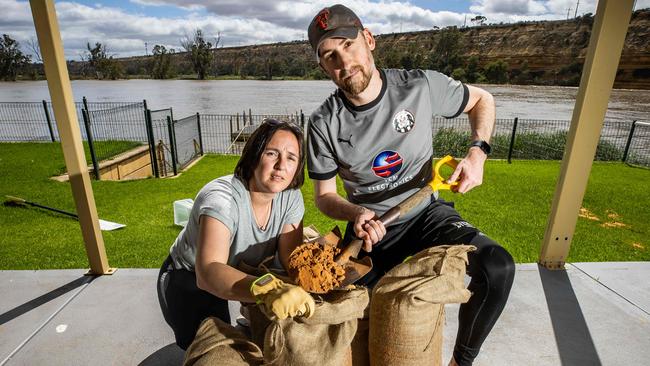 Nathan and Carly Case filling sandbags at their holiday home in Blanchetown. Picture: Tom Huntley