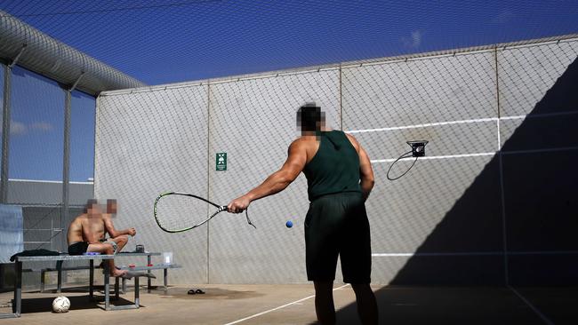 Inmates playing racquet ball in the exercise yard. Picture: Sam Ruttyn