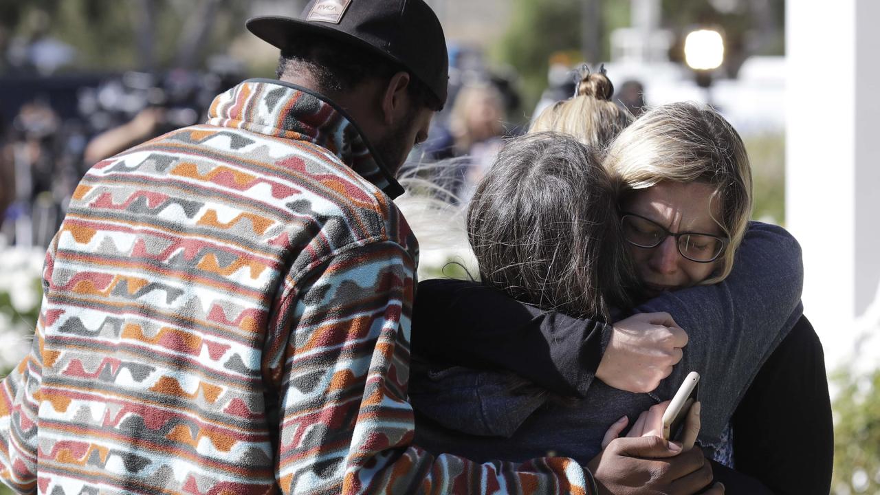 Mourners embrace outside of the Thousand Oaks Teen Center. Picture: AP