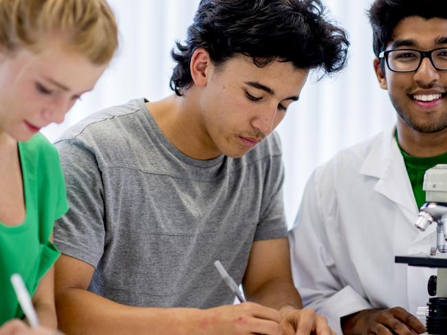 Students Working with a Microscope - Stock image  ipad generic