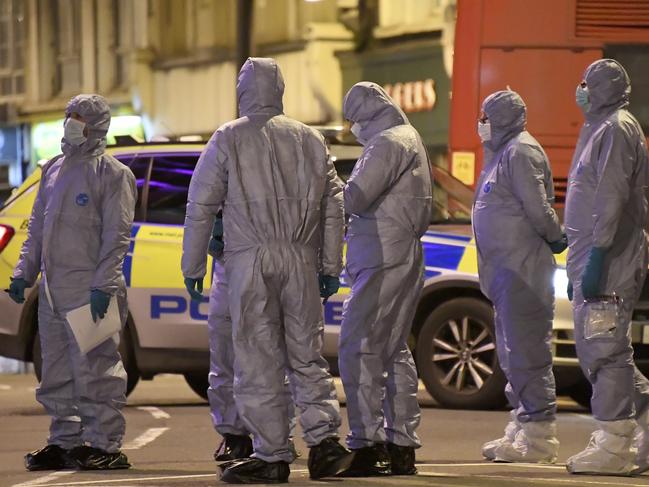 Police forensic officers work near the scene after a stabbing incident in London. Picture: AP