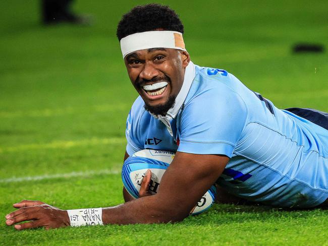 Waratahs' Vuate Karawalevu scores a try with one of the few smiles out of the NSW camp. Picture: AFP