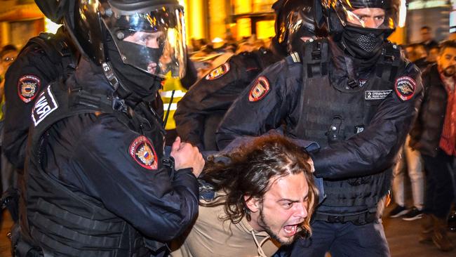 Police officers detain a man during a protest against partial mobilisation. Picture: AFP.