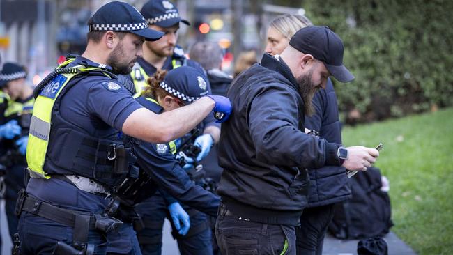Protesters demanding that police cease operations are stopped in the city. Picture: Jake Nowakowski