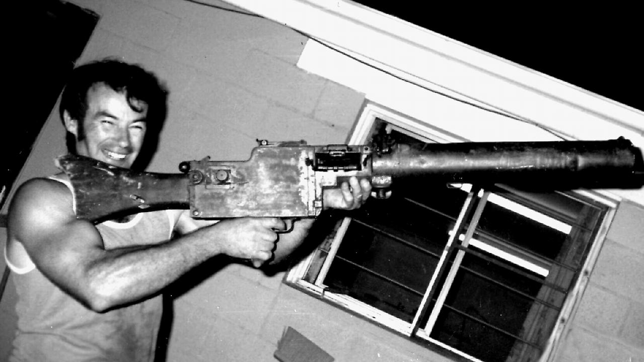 Ivan Milat pictured in 1983, holding a World War One vintage machine gun.