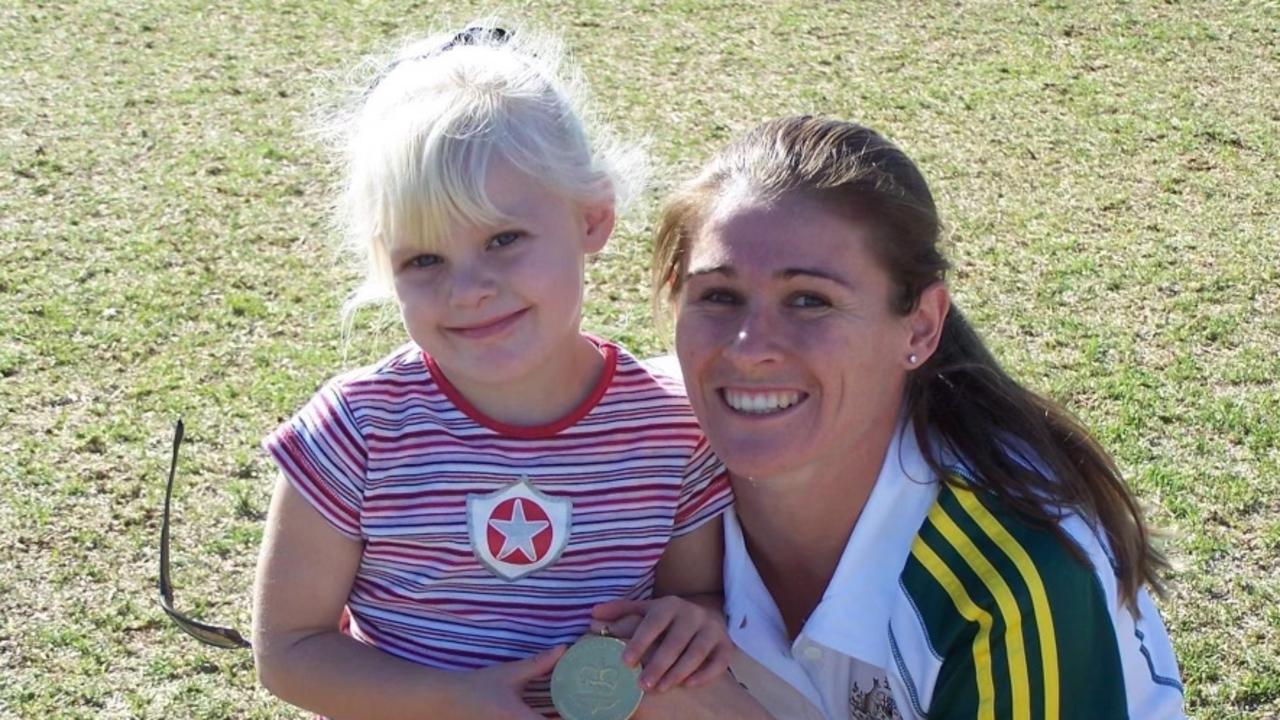 Tatum Stewart as a child with then Hockeyroo Angie Lambert