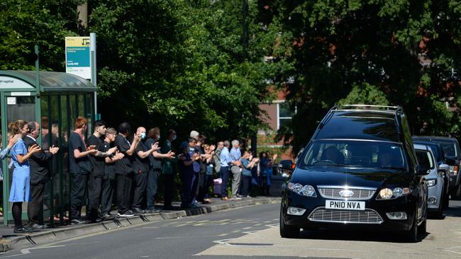 The funeral cortege for Mike Brown passes the entrance of the Southampton General Hospital in Southampton, England, on Friday. Brown, 61, died at the hospital, where he had worked for 20 years, after testing positive for COVID-19. Picture: Getty Images