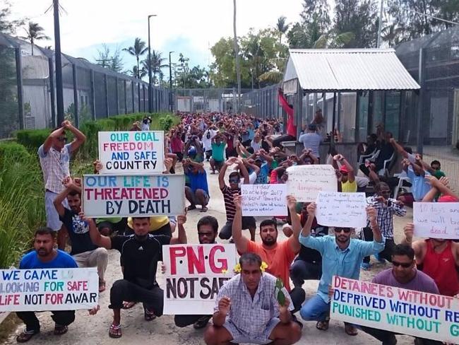 The men hold up banners during one of their daily protests at the Manus Island immigration detention centre in Papua New Guinea. Picture: Refugee Action Coalition via AP