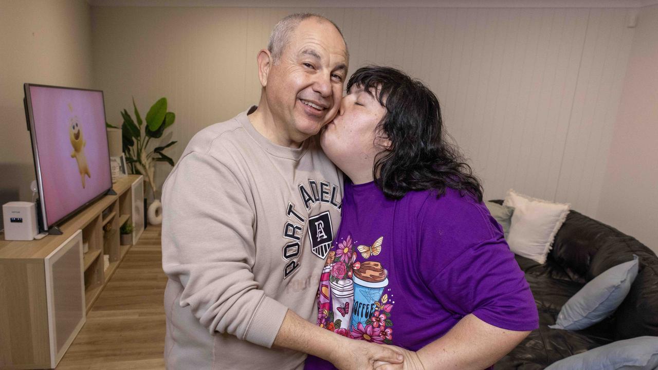 Georgia Kosteriadis with her dad Alex Kosteriadis at their home in Seaton. They are on the verge of being evicted after the NDIS rejected increased funding for their daughter against the medical advice. Picture: Kelly Barnes