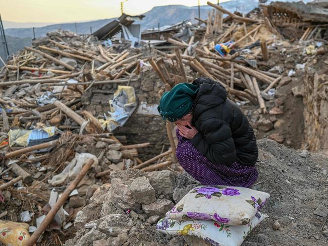 A woman crying as she sits atop the rubble of her collapsed house in Yaylakonak village in Adiyaman district, a Kurdish alevi community. Picture: AFP