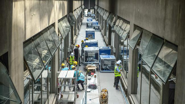 Employees work at a makeshift hospital that will be used for Covid-19 coronavirus patients in Guangzhou. Picture: AFP.