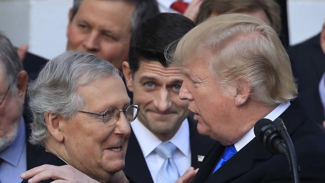 President Donald Trump congratulates Senate Majority Leader Mitch McConnell  after the final passage of tax overhaul legislation. Australia must follow suit.