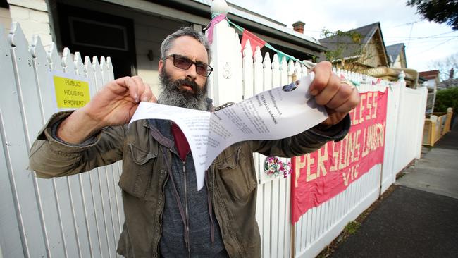 Joel Bynon tears up an eviction notice. Picture: Norm Oorloff