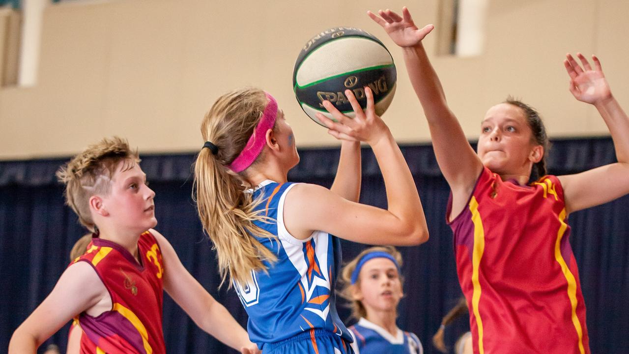 Gympie Basketball primary school grand finals – Lara Jenkin tries to shoot over MVP Caitlin Killian. Photo: Miguel Galy