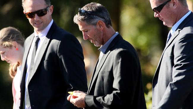 Father Aaron Cockman, centre, after the service. Picture: Colin Murty