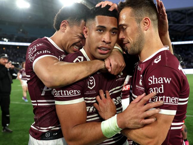 SYDNEY, AUSTRALIA - SEPTEMBER 15: Lehi Hopoate of the Sea Eagles, Tolutau Koula of the Sea Eagles and LukeÃÂ Brooks of the Sea Eagles embrace after winning during the NRL Qualifying Final match between Canterbury Bulldogs and Manly Sea Eagles at Accor Stadium on September 15, 2024 in Sydney, Australia. (Photo by Cameron Spencer/Getty Images)