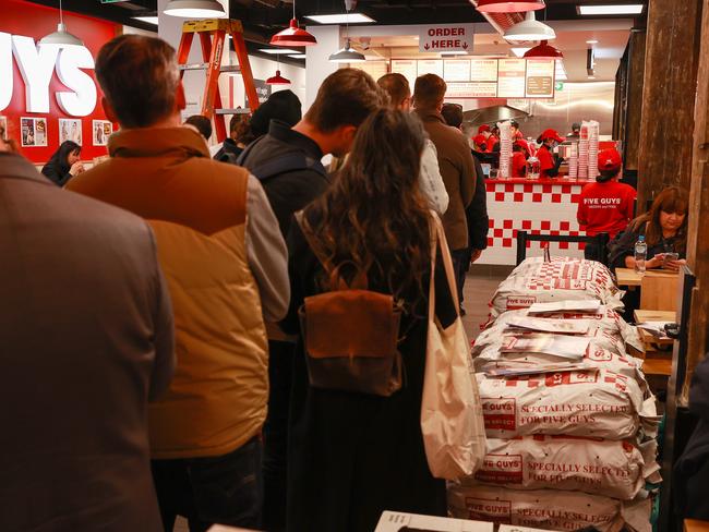 Daily Telegraph. 06, June, 2022.People waiting to order at the opening Cult US fast food franchise Five Guys, in Sydney CBD, today. Picture: Justin Lloyd.