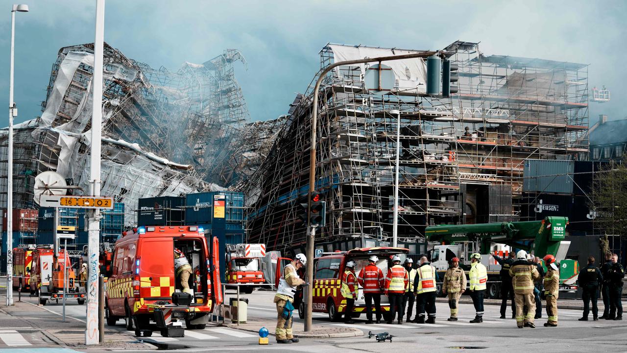 Firefighters stand by as the facade of Copenhagen’s historic Borsen collapses, following a fire that consumed half of the 17th-century building and its iconic spire. Picture: Thomas Traasdahl/Ritzau Scanpix/AFP