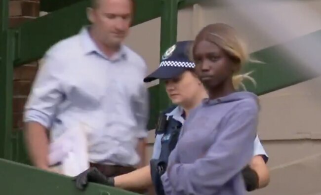 Kofan donned black slacks and a dark grey hoodie with her hood cover on as she was escorted by police to court cells this morning ahead of her appearance. Source: Channel 10