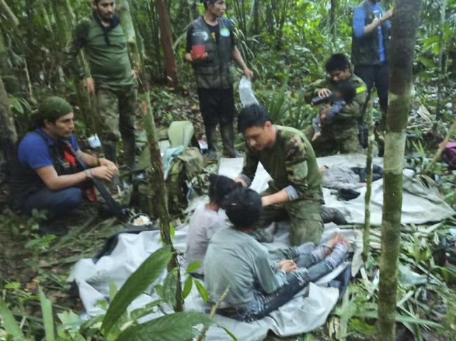 In this handout photo released on June 9, 2023, by the Colombian Presidency, members of the army assist four Indigenous children who were found alive after spending more than a month lost in the Colombian Amazon jungle following the crash of a small plane. Four Indigenous children were found alive Friday after spending more than a month lost in the Colombian Amazon rainforest following a small plane crash that triggered a massive rescue operation, the country's President Gustavo Petro said. (Photo by PRENSA PRESIDENCIA / Colombian Presidency / AFP) / RESTRICTED TO EDITORIAL USE - MANDATORY CREDIT "AFP PHOTO / Colombian Presidency" - NO MARKETING - NO ADVERTISING CAMPAIGNS - DISTRIBUTED AS A SERVICE TO CLIENTS