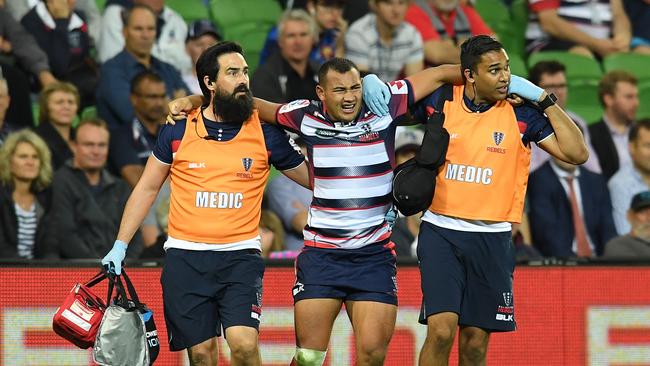 Jonah Placid of the Rebels is taken off the field injured after colliding with Matt Duffie of the Blues.