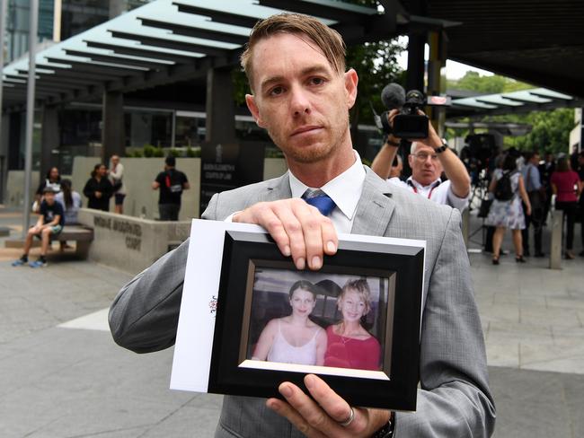 Michael Cook, brother of Cindy Low, holds a picture of her as he leaves the Magistrates Court in Brisbane. (AAP Image/Dan Peled)