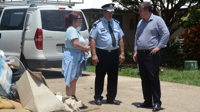 Police Commissioner Ian Stewart and Police Minister Mark Ryan speak to Tracey Hartman in front of her flooded home on Kokoda St. Picture: Chris Lees