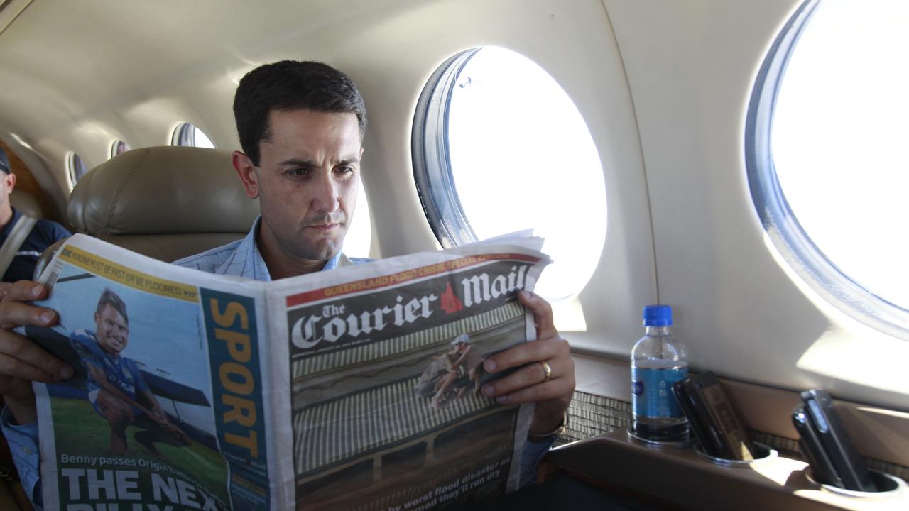 BCM 30.1.2013 QLD regional flood tour with Deputy Premier Jeff Seeney and David Crisafulli. Mr Crisafulli reads the Courier Mail while on the plane to Gympie. Pic Jono Searle