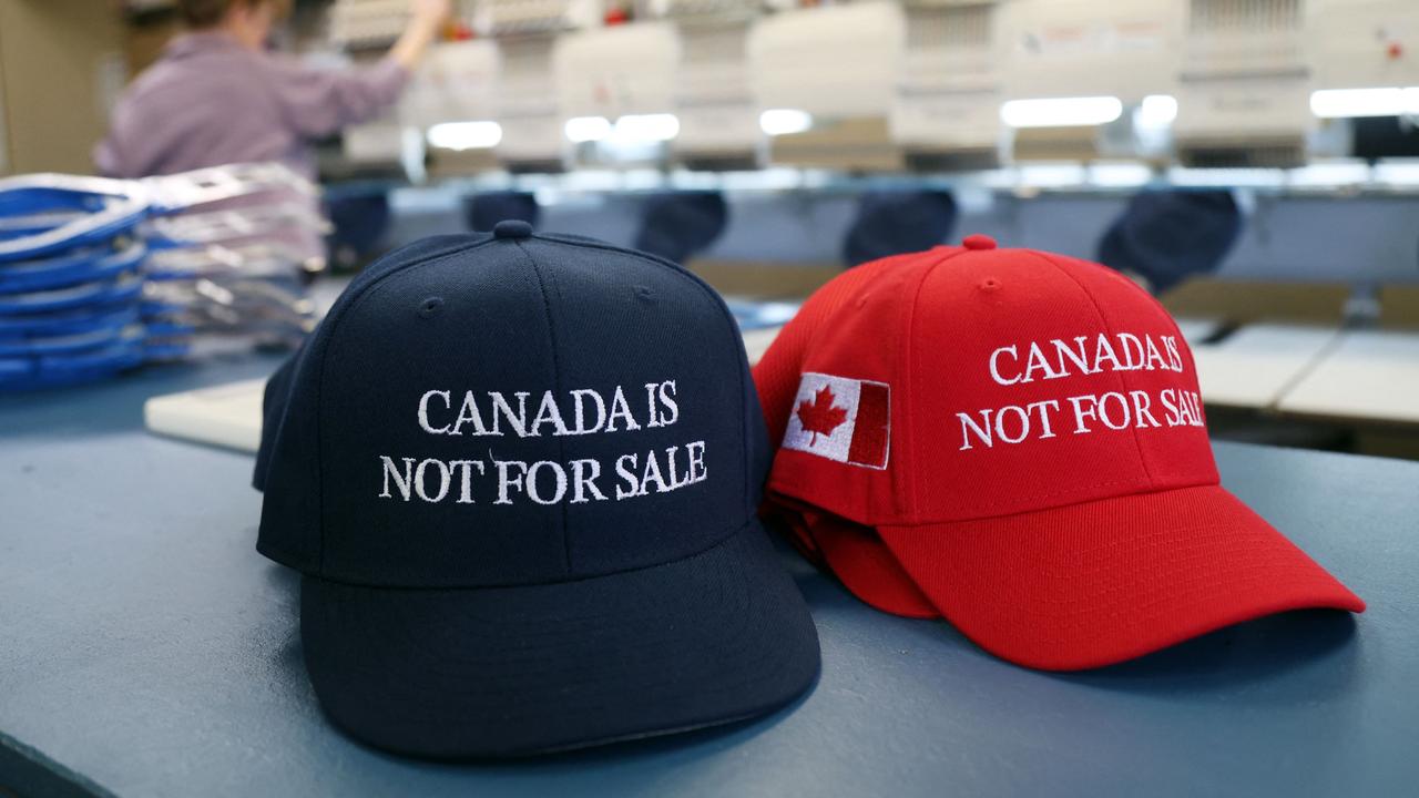 "Canada is Not For Sale" hats are bestsellers. (Photo by Dave Chan / AFP)