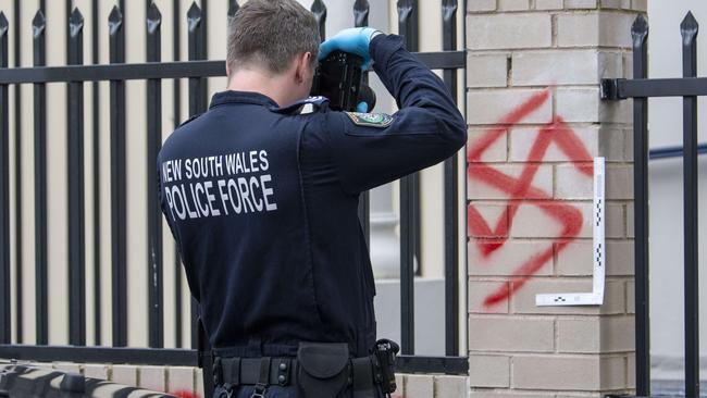 Police inspect Newtown Synagogue on January 11 after it was tagged with Nazi symbols. Two people have since been charged. Picture: Simon Bullard