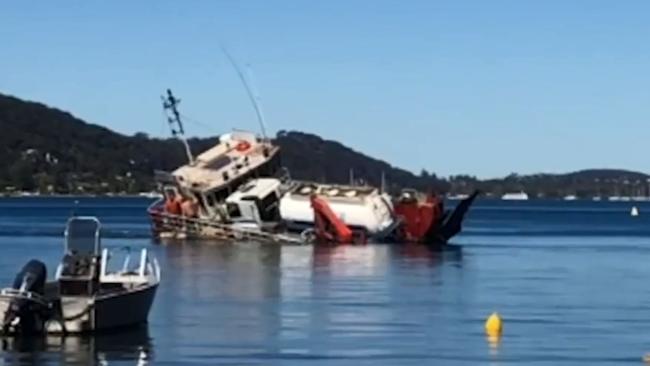 Four men had to be rescued when a barge ferrying a truck overturned on Pittwater in Sydney. Picture: Supplied